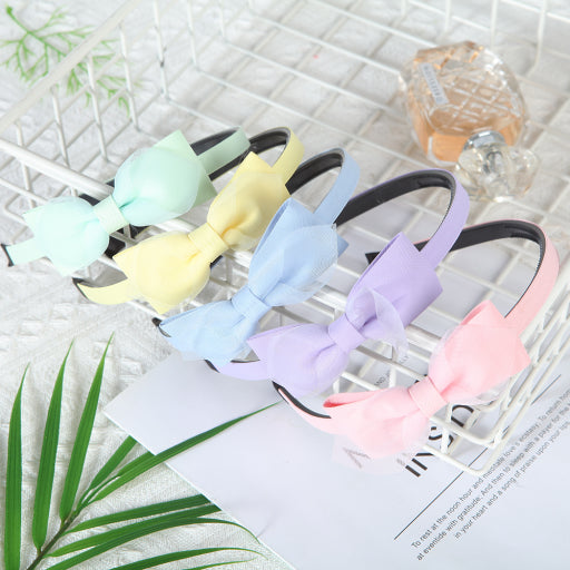 Diadema con moño de color liso de malla