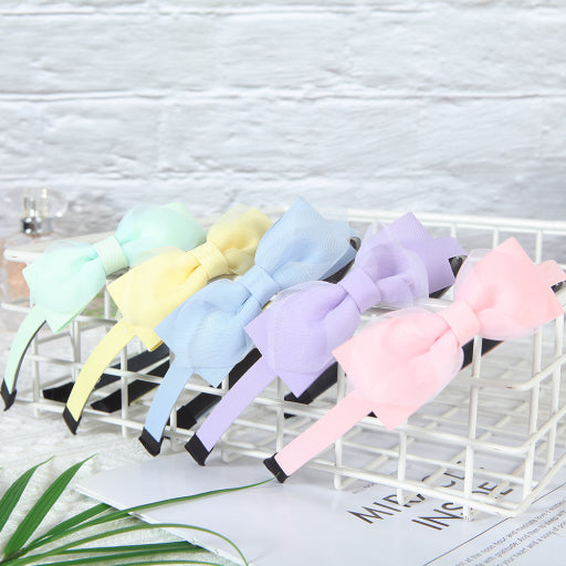 Diadema con moño de color liso de malla