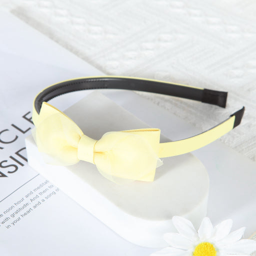 Diadema con moño de color liso de malla