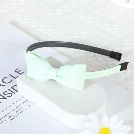 Diadema con moño de color liso de malla